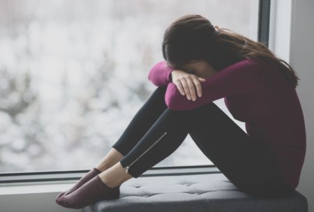 depressed woman covering her face