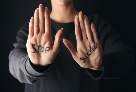 person stop suicide written on palms