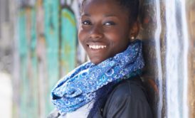 smiling woman in jacket and blue scarf