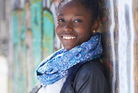 smiling woman in jacket and blue scarf