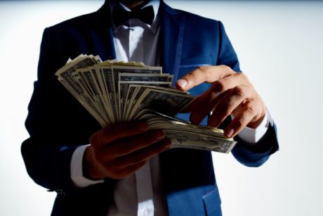 millionaire holding paper money