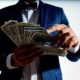 millionaire holding paper money