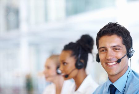 a man with a headset, smiling in an office setting, symbolizing customer service excellence