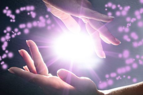 hands reaching out towards the seven rays of light, symbolizing hope and connection to a higher power