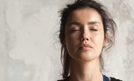 Serene woman practicing Eye Yoga with closed eyes, promoting relaxation and mindfulness through the soothing benefits of eye yoga exercises