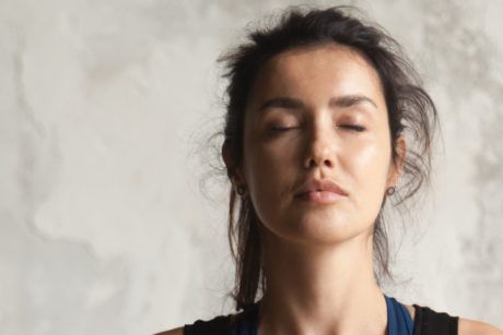 Serene woman practicing Eye Yoga with closed eyes, promoting relaxation and mindfulness through the soothing benefits of eye yoga exercises