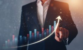 a businessman's hand points up on a graph, symbolizing business growth and a thought leadership strategy