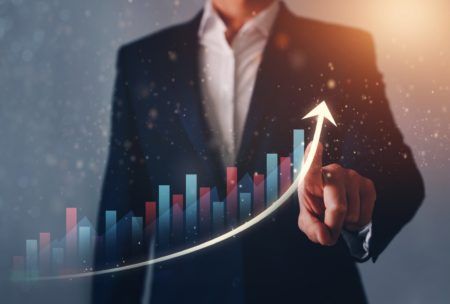a businessman's hand points up on a graph, symbolizing business growth and a thought leadership strategy