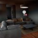 a dimly lit room featuring a couch and a lamp, showcasing a scene from an Unreal Engine 5 tutorial