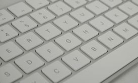 white computer keyboard displaying letters, used for transcription from home