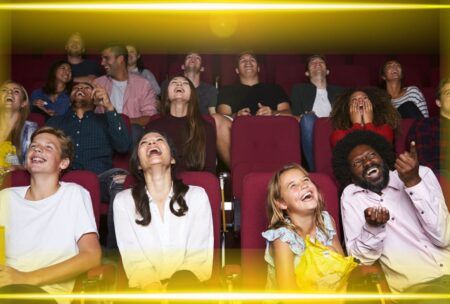 q gathering of people in a movie theater, engaged in watching a film, surrounded by the ambiance of cinematic excitement