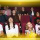 q gathering of people in a movie theater, engaged in watching a film, surrounded by the ambiance of cinematic excitement