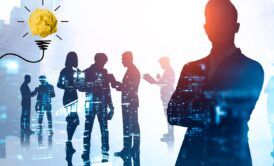business leaders gathered around a light bulb, illustrating concepts of innovation and team leadership development
