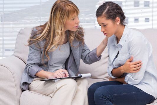 therapist performing solution focused brief therapy on a patient