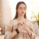 Woman practicing energy psychology techniques, meditating with her hands on her chest.