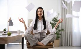 Employee practicing meditation at work, fostering a calm and focused environment for enhanced productivity.