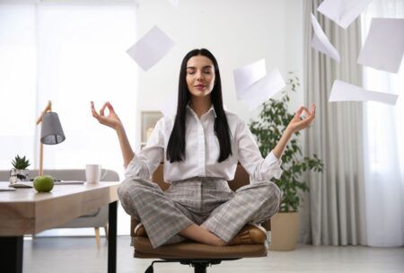 Employee practicing meditation at work, fostering a calm and focused environment for enhanced productivity.