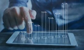 A businessman using a tablet to display graphs on the screen. Relevant to Capsim business simulation