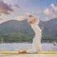 A woman performing Kundalini yoga by a tranquil lake