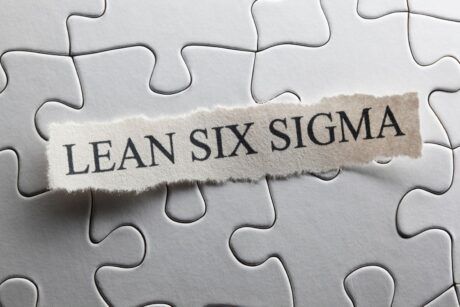Jigsaw puzzle piece with 'lean six sigma' written on it. Symbolizes the concept of lean six sigma yellow belt