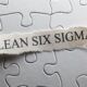 Jigsaw puzzle piece with 'lean six sigma' written on it. Symbolizes the concept of lean six sigma yellow belt