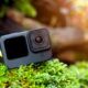 An action camera on a mossy rock - perfect GoPro for beginners