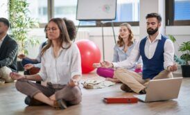 Group meditation session in a yoga class, promoting calmness and stress relief.