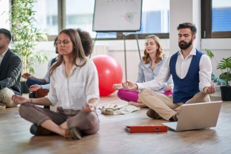 Group meditation session in a yoga class, promoting calmness and stress relief.