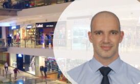 Professional man in tie and shirt at a mall. LEED Green Associate Exam.