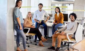 a diverse group of professionals sitting in an office during a confidence course