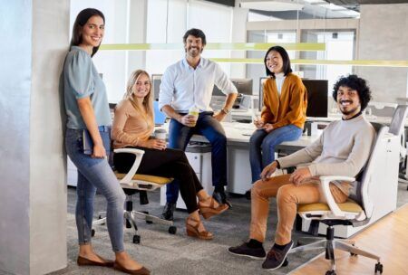 a diverse group of professionals sitting in an office during a confidence course
