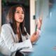 A woman in a business suit giving advice on how to be more assertive.