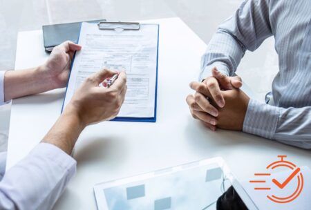 two individuals at a table with a clipboard, engaged in a consultative selling course