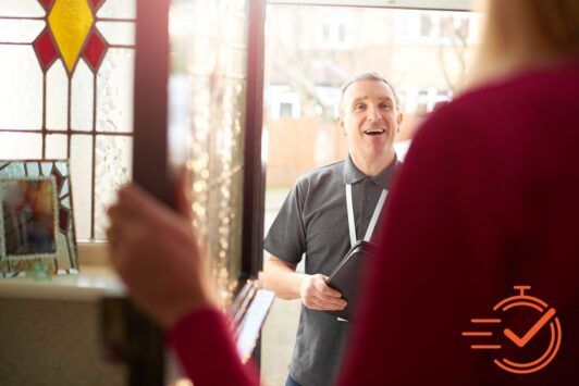 A man and woman smiling in front of a door, ready for their door-to-door sales pitch.