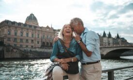 smiling couple on bridge exploring the joy of gerontology and psychology of aging