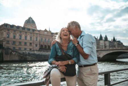 smiling couple on bridge exploring the joy of gerontology and psychology of aging
