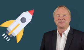 a man in formal attire stands alongside a rocket, illustrating concepts of leadership and management training in a futuristic setting