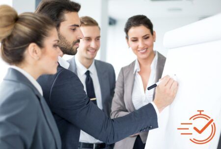 business professionals in a positive training environment, attentively gathered around a whiteboard for a meeting