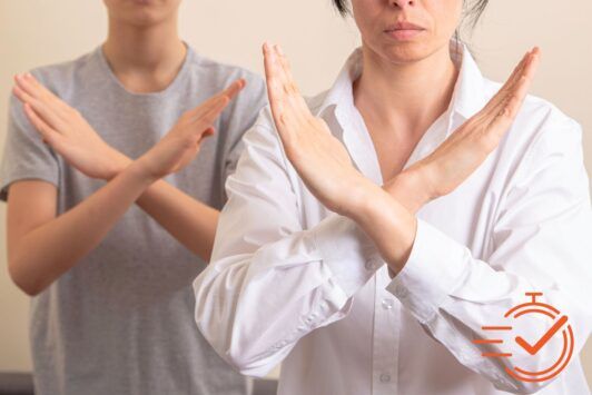 Two individuals use hand gestures to convey a message, reflecting the nuances of unconscious bias training in their interaction