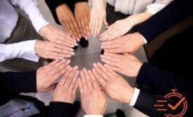 diverse business team forming a circle with hands together, representing engaging your people in the workplace