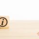 a wooden block on a desk representing a guide on keep your customers informed of your products and services