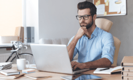 a man focused on his laptop during a power apps training session
