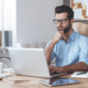 a man focused on his laptop during a power apps training session