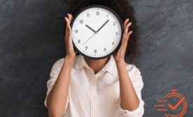A woman covers her face with a clock, representing time management training