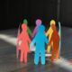 A circle of diverse paper cutouts representing people, highlighting themes of equity and inclusion in training sessions.