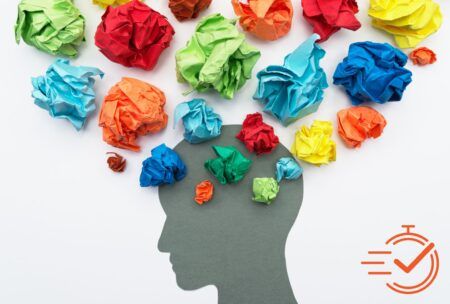 A head filled with crumpled colored paper, illustrating the struggle to enhance mental endurance and clarity.