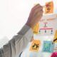 A businessman brainstorming on sticky notes on a whiteboard, highlighting strategies from the best project management course.