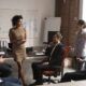 a diverse group of professionals engaged in a coaching business training meeting in a modern office setting