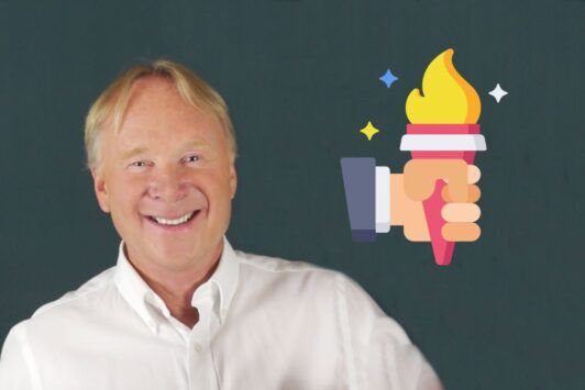 a smiling chris croft with a torch in the background, representing inspirational leadership and the illumination of hope and guidance for others