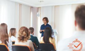 A person delivers an informative presentation to a group, fostering a collaborative learning atmosphere.